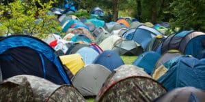 People leave tents in fields