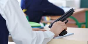 A boy shoots his teacher